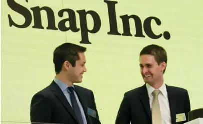  ?? AP FILE PHOTO ?? RINGING IN CHANGE: Since Snapchat founders Bobby Murphy and Evan Spiegel, from left, took Snapchat public in March, the company’s revenue hasn’t grown enough for Wall Street analysts.