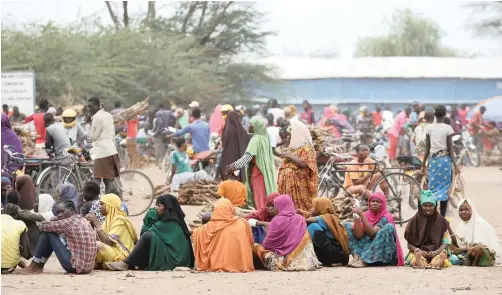  ?? | BAZ RATNER Reuters ?? WOMEN wait in line to receive aid at the Kakuma refugee camp in northern Kenya in this March 2018 file picture