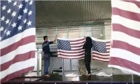  ?? Photograph: Wana News Agency/Reuters ?? Iranian workers collect US flags after making them at a flag factory in Khomein, Iran, on 28 January.