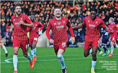  ?? ?? Alfie May, centre, celebrates his winner against Wycombe