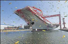  ?? REUTERS ?? China's first domestical­ly built aircraft carrier during its launching ceremony in Dalian, Liaoning province on Wednesday.