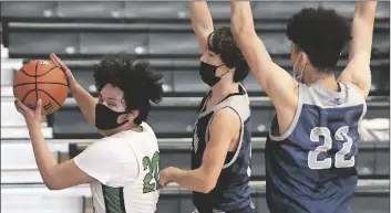  ?? PHOTO BY rANdY HOeFT/YUMA ?? BUY THeSe PHOTOS AT YUMASUN.COM SUN SAN LUIS’ EFREN MIGUEL CORRALES (left) looks to drive the baseline while being defended by Surprise-Willow Canyon’s Pike Bryce Hanson (center) and Julian Taylor) during the second quarter of Monday afternoon’s season-opening basketball game for both teams at San Luis.