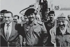 ?? AP file photos ?? October 24, 1988: Iraqi president Saddam Hussein greets president Hosni Mubarak and Yasser Arafat in Baghdad. —