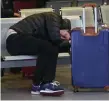  ??  ?? A stranded passenger tries to sleep it off in Dublin Airport