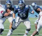  ?? COURTESY OF GEORGETOWN ?? Georgetown junior offensive lineman Neal Azar, middle, was disappoint­ed he won’t be able to play football this fall. But the Granby High graduate is looking at the bright side. It will give him a chance to work on his footwork and get stronger and faster.