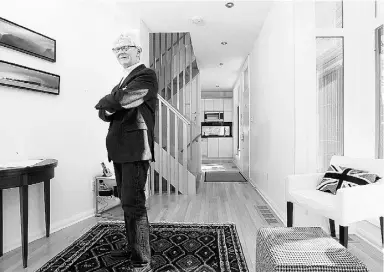  ?? Julie Oliver / Ottawa Citizen ?? Architect Robert Matthews poses in his teeny-tiny Ottawa house that feels huge and airy. Matthews is photograph­ed in his living room on the main floor.