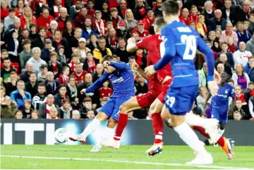  ?? — Reuters photo ?? Eden Hazard (left) scores their second goal during the English League Cup third round match between Liverpool and Chelsea at Anfield in Liverpool, north west England.