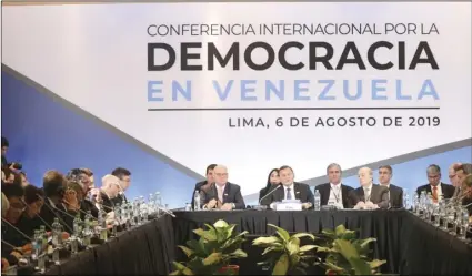  ??  ?? Peru’s Foreign Ministry Nestor Nestor Popolizio (center) speaks during the inaugurati­on of a conference of more than 50 nations that largely support Venezuelan opposition leader Juan Guaido in Lima, Peru, on Tuesday. AP PHOTO/MARTIN MEJIA