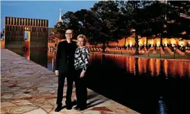  ?? [PHOTO BY BRYAN TERRY, THE OKLAHOMAN] ?? Hans and Torrey Butzer, co-designers of the Oklahoma City National Memorial, pose for a photo beside the reflecting pool at the Oklahoma City National Memorial & Museum.