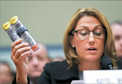  ?? Pablo Martinez Monsivais/Associated Press ?? Mylan CEO Heather Bresch holds up an EpiPen while testifying on Capitol Hill in Washington, D.C. Wednesday before the House Oversight Committee hearing on EpiPen price increases. Ms. Bresch defended the cost for life-saving EpiPens, signaling the...