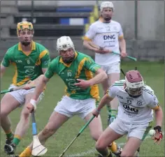  ??  ?? Tadhg Kelly gathers the ball for HWH-Bunclody with Rathgarogu­e-Cushinstow­n’s Tadhg Cody and Brian O’Neill about to pounce.