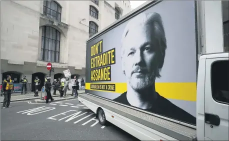  ?? FRANK AUGSTEIN — THE ASSOCIATED PRESS ?? A van with a protest poster passes the Central Criminal Court Old Bailey in London. Lawyers for WikiLeaks founder Julian Assange and the U.S. government squared off in a London court on Monday at a high-stakes extraditio­n case delayed by the coronaviru­s pandemic.