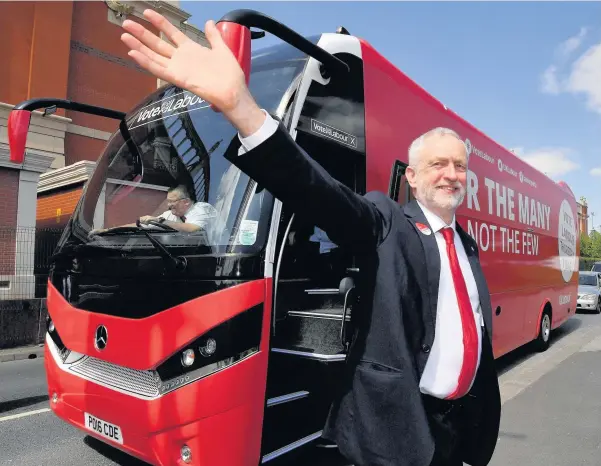  ??  ?? > Labour Party leader Jeremy Corbyn gestures as he boards the party campaign bus following their General Election launch in Manchester yesterday