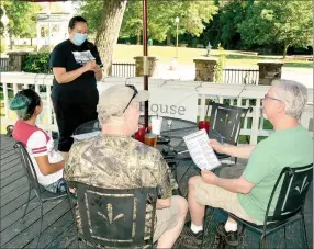  ?? Marc Hayot/Herald Leader ?? Alma Sanchez may be the owner of Park House Kitchen + Bar, but she doesn’t mind doing all the jobs from waiting tables to serving food. Here Sanchez takes the dinner order of some customers.