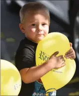  ??  ?? Kaidyn Henshaw, 3, enjoys playing with a balloon Saturday, Oct. 27, 2018 at the 110th anniversar­y celebratio­n at the Recorder office.