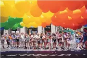  ?? MARY ALTAFFER/ ASSOCIATED PRESS ?? Spectators watch as revelers march down Fifth Avenue during the annual NYC Pride March on Sunday.