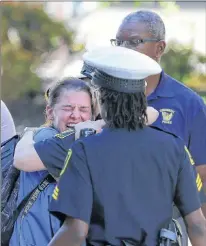  ?? KAREEM ELGAZZAR/THE CINCINNATI ENQUIRER VIA AP ?? A woman is comforted by authoritie­s stationed outside the University of Cincinnati Medical Center’s Emergency room following a shooting in downtown Cincinnati Thursday.