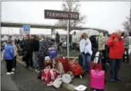  ?? THIBAULT CAMUS — THE ASSOCIATED PRESS ?? Travelers wait outside the Orly Airport, south of Paris, Saturday. A man was shot dead after wrestling a soldier to the ground at Paris’ Orly Airport and trying to take her rifle, officials said. No one else in the busy terminal was hurt, but thousands...