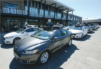 ?? (Aaron Josefczyk/Reuters) ?? A FLEET of Uber’s Ford Fusion self-driving cars are shown during a demonstrat­ion of self-driving automotive technology in Pittsburgh on Tuesday. The launch of Uber’s self-driving pilot program marks the public unveiling of the company’s secretive work...