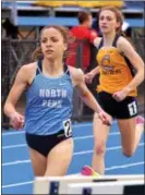  ?? DIGITAL FIRST MEDIA FILE PHOTO ?? North Penn’s Ariana Gardizy withstands a challenge from Cheltenham’s Mary Grace Rittler in the 1600 meter run at the Trojan Classic earlier this season.