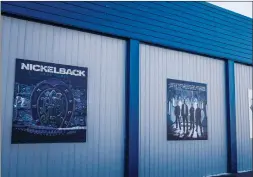  ?? THE CANADIAN PRESS/JEFF MCINTOSH ?? Murals of home town band Nickelback adorn the curling rink in Hanna, Alta., Dec. 13. Love 'em or hate 'em, chances are you at least know their name.