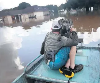  ?? Joe Raedle Getty Images ?? IN LOUISIANA in August, global warming made record f loods at least 40% more likely.