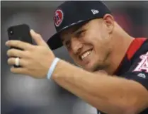  ?? PATRICK SEMANSKY - THE ASSOCIATED PRESS ?? FILE - In this July 16, 2018, file photo, American League AllStar Mike Trout, of the Los Angeles Angels, takes a photo on the field ahead of the All-Star Home Run Derby at Nationals Park in Washington.