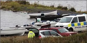  ??  ?? Search operation: Emergency services personnel at Loch of Boardhouse yesterday