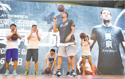  ?? VCG via Getty Images ?? Klay Thompson demonstrat­es his ball-handling skills for fans in June at the Happy Family Mall in Shenyang, China.