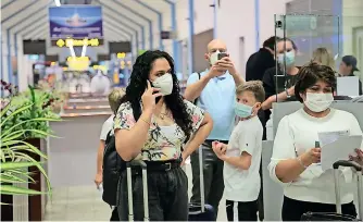  ??  ?? File picture of tourists at the airport. Tourism earnings have been badly affected by the pandemic.