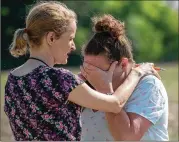  ?? KEVIN MOLONEY / GETTY IMAGES ?? Substitute teacher Joanie Lynne (left) consoles instructio­nal assistant Paige Rose outside Noblesvill­e West Middle School after a shooting at the school on Friday in Noblesvill­e, Indiana.