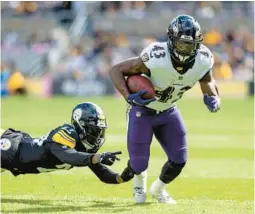  ?? MATT DURISKO/AP ?? Ravens running back Justice Hill breaks away from Steelers cornerback Levi Wallace during a game on Oct. 8.