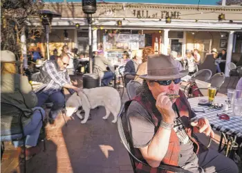  ?? GABRIELA CAMPOS/THE NEW MEXICAN ?? Freddy Lopez plays his harmonica as a band performs for patrons April 9 on Cowgirl BBQ’s patio.