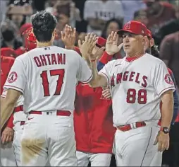  ?? Robert Gauthier Los Angeles Times ?? ANGELS MANAGER Phil Nevin, congratula­ting pitcher Shohei Ohtani after a win last season, is trying to promote a climate of positivity and winning.