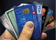  ?? RYAN REMIORZ/THE CANADIAN PRESS FILE PHOTO ?? A cardinal rule of consolidat­ion is not using your credit cards as you pay off debt. Some people lock their cards away.