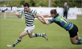  ??  ?? Ryan O’Loughlin looks to skip away from this challenge during the Leinster Senior League clash.