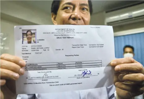  ?? (SUN.STAR FOTOS/ALAN TANGCAWAN [RAMA] & JOHANNA MARIE O. BAJENTING) ?? THEY DON’T SEEM TESTY, DO THEY? Lawyer Michael Rama shows a lab result that says there was no trace of meth or cannabis in his urine sample. He also submitted a hair follicle in a test similar to what Cebu City Mayor Tomas Osmeña (right) underwent...
