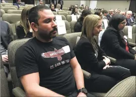  ?? KATHLEEN RONAYNE — THE ASSOCIATED PRESS ?? Shane Fedderman, left, a 1998 graduate of Marjory Stoneman Douglas High School in Parkland, Fla., watches as families of mass-shooting victims urge California’s public pension funds to stop investing in retailers of assault weapons.
