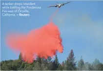  ?? — Reuters ?? A tanker drops retardant while battling the Ponderosa Fire east of Oroville, California.