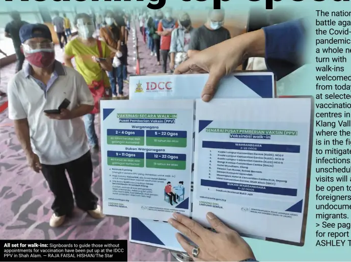  ?? — RAJA FAISAL HISHAN/THE Star ?? All set for walk-ins: Signboards to guide those without appointmen­ts for vaccinatio­n have been put up at the IDCC PPV in Shah Alam.