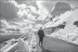  ?? KARL MONDON/BAY AREA NEWS GROUP ?? Lick Observator­y’s Elinor Gates walks back from the Grand Refractor telescope on Tuesday, saying this is the most snow she’s ever seen atop Mount Hamilton in her 25 years as the resident astronomer.