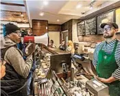  ?? JESSICA GRIFFIN/PHILADELPH­IA INQUIRER ?? Activist Asa Khalif, left, protests inside the Starbucks where two black men were arrested.