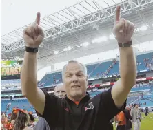  ?? AP PHOTO ?? ONE PLUS ONE EQUALS ... Coach Mark Richt celebrates Miami’s victory Saturday against Virginia, which propelled the Hurricanes to No. 2 in the latest College Football Playoff rankings released last night.