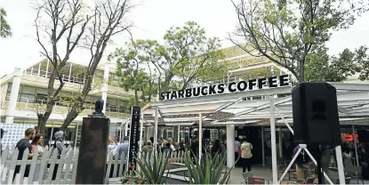  ?? Picture: SIZWE NDINGANE ?? NEW WORLDS: People help themselves to refreshmen­ts during the opening of the Starbucks store in Rosebank, Johannesbu­rg. The store is the popular US coffee chain’s first outlet in sub-Saharan Africa