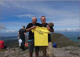  ??  ?? Climb Organisers Ger Morrissey (left) and Padraig Breen (right) with the Irish Cancer Society t-shirt.