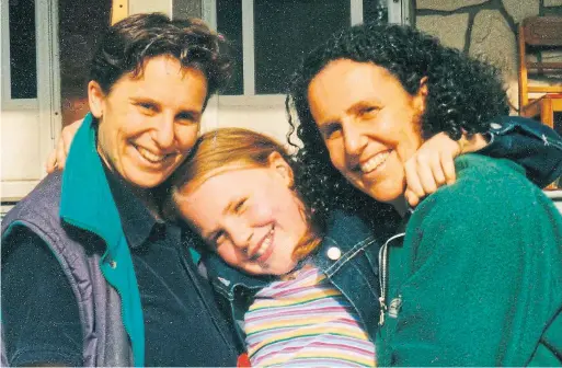  ??  ?? Sadie Epstein-Fine, centre, with moms Lois Fine, left, and Rachel Epstein. Epstein-Fine co-authored an anthology of first-person essays about having LGBTQ parents.