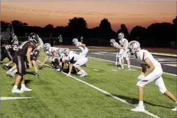  ?? Graham Thomas/Siloam Sunday ?? The sun sets at Blackhawk Stadium in Pea Ridge as the Siloam Springs offense prepares to snap the ball deep in its own territory. The Panthers’ offense is averaging nearly 535 offensive yards per game through its first three games.