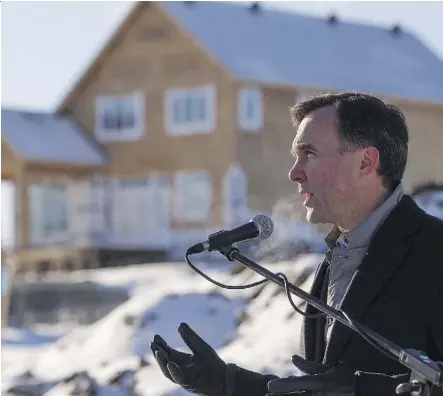  ?? AMBER BRACKEN/THE CANADIAN PRESS ?? Finance Minister Bill Morneau says Fort McMurray residents will get a compensati­on package from drywall duties, and minimum import prices would be cut by over 32 per cent.