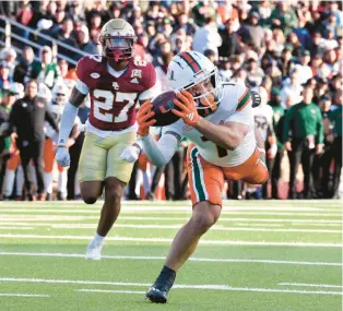  ?? MARK STOCKWELL/AP ?? Miami wide receiver Xavier Restrepo reaches for a reception against Boston College on Friday. Restrepo finished with six catches for 117 yards.