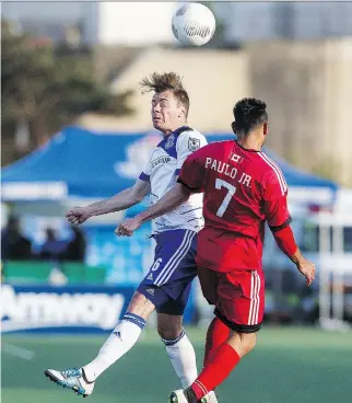  ?? IAN KUCERAK ?? Edmonton’s Nik Ledgerwood and Ottawa’s Paulo Junior jump for a ball during the NASL game between FC Edmonton and the Ottawa Fury FC at Clarke Stadium in Edmonton on Wednesday.